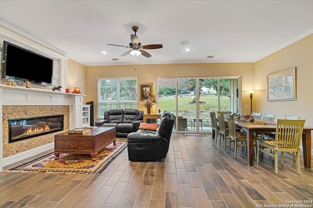 living room with hardwood / wood-style floors, crown molding, and a wealth of natural light