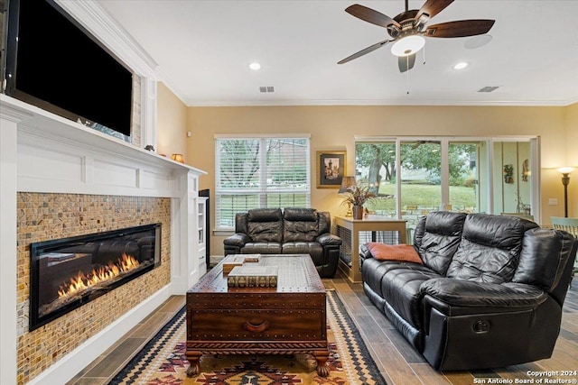 living room featuring ceiling fan, ornamental molding, and hardwood / wood-style flooring