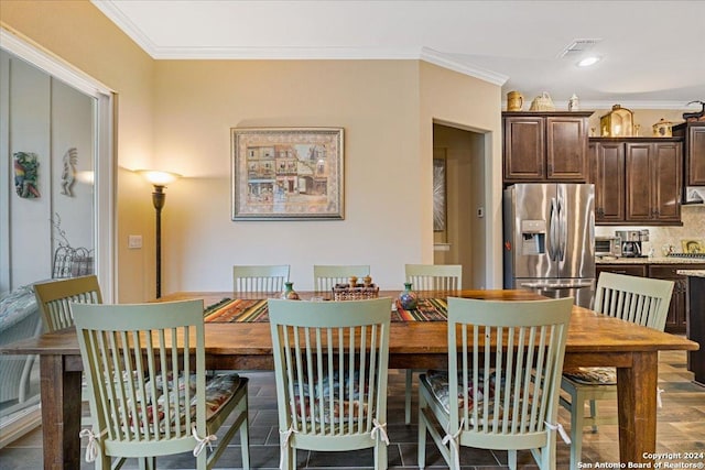 dining room with hardwood / wood-style flooring and ornamental molding