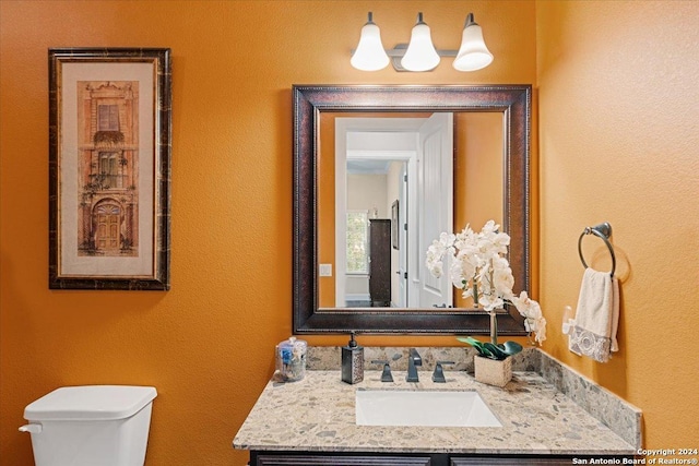 bathroom featuring vanity and toilet