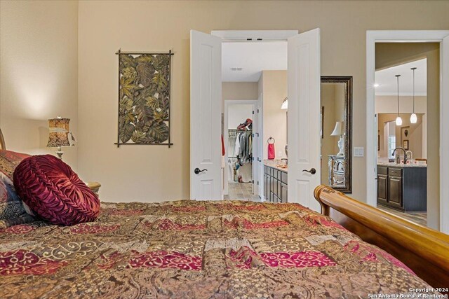 bedroom with ensuite bath and sink