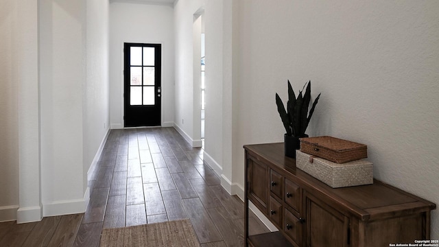 foyer with wood tiled floor and baseboards