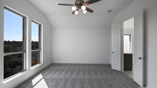 interior space featuring carpet, visible vents, vaulted ceiling, and baseboards