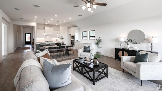 living room with light wood finished floors, baseboards, visible vents, and recessed lighting