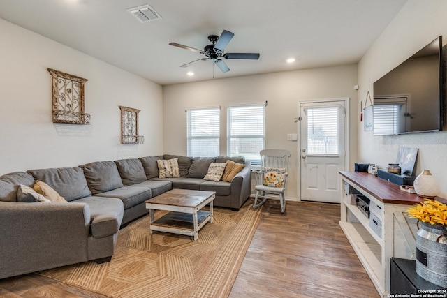 living room with hardwood / wood-style floors and ceiling fan