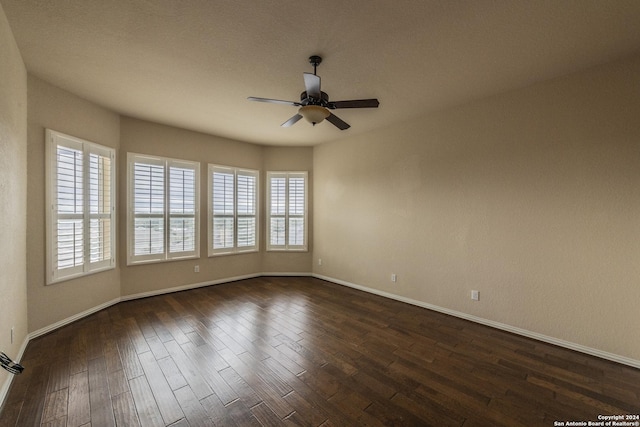 spare room with ceiling fan and dark hardwood / wood-style flooring