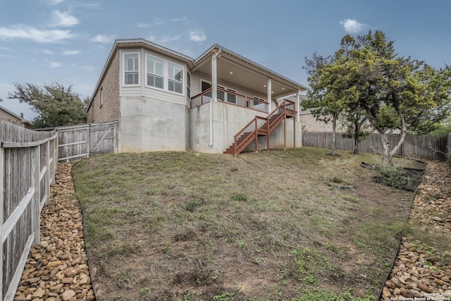 rear view of property with a yard