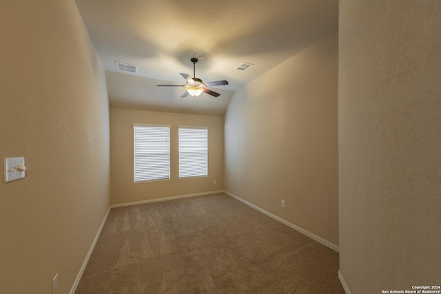 unfurnished room featuring lofted ceiling, ceiling fan, and carpet floors