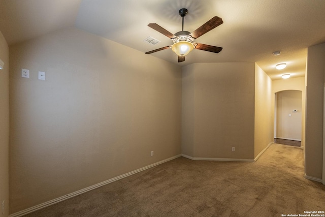 carpeted empty room with ceiling fan and lofted ceiling