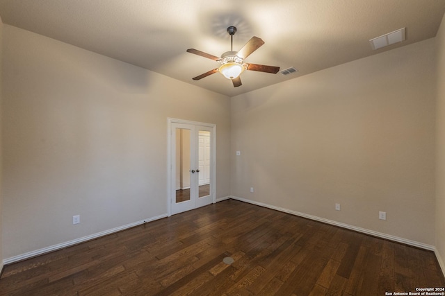 empty room with dark hardwood / wood-style floors, ceiling fan, and french doors