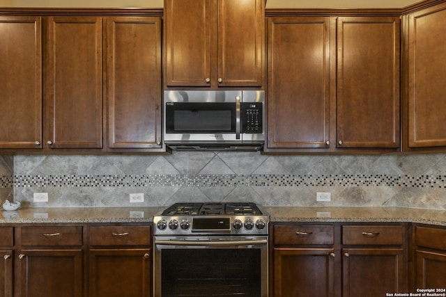 kitchen featuring decorative backsplash, light stone counters, and stainless steel appliances