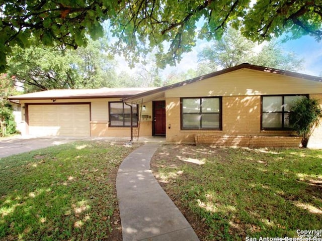 ranch-style house featuring a garage and a front yard