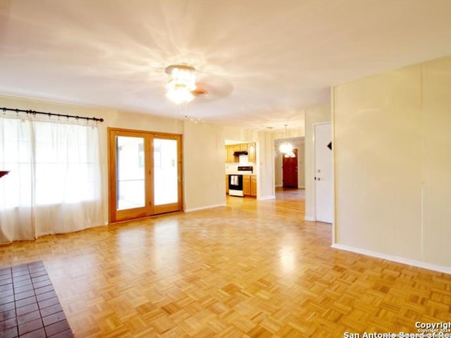 spare room featuring ceiling fan and light parquet flooring