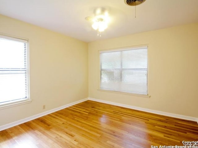 empty room featuring hardwood / wood-style flooring and ceiling fan