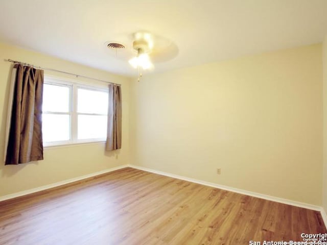 empty room with light hardwood / wood-style flooring