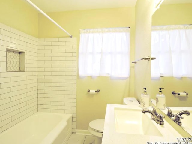 full bathroom with toilet, tiled shower / bath, and sink