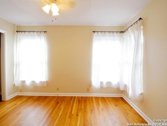 spare room with wood-type flooring and ceiling fan