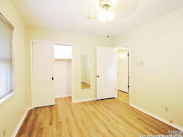 unfurnished bedroom with a closet, light hardwood / wood-style flooring, and ceiling fan