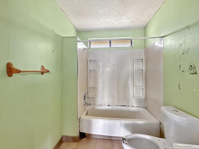 bathroom with tile patterned floors, shower / washtub combination, a textured ceiling, and toilet