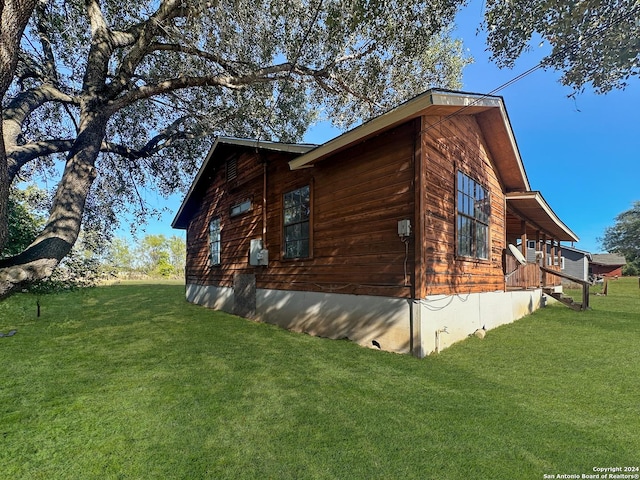 view of home's exterior with a yard