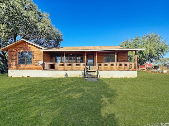 ranch-style home with covered porch and a front yard