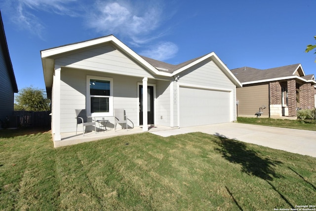 ranch-style house featuring a garage and a front lawn