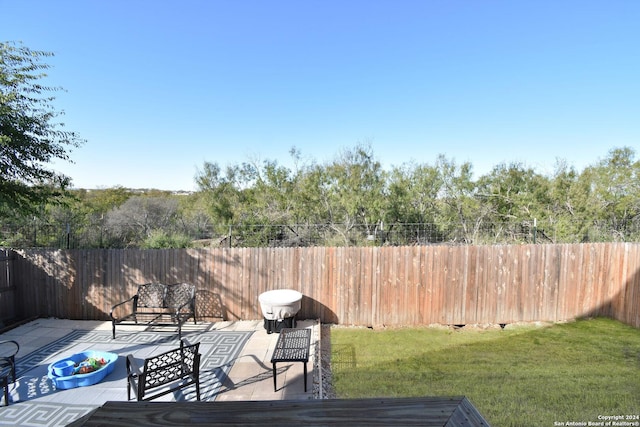 wooden terrace featuring a patio area and a yard