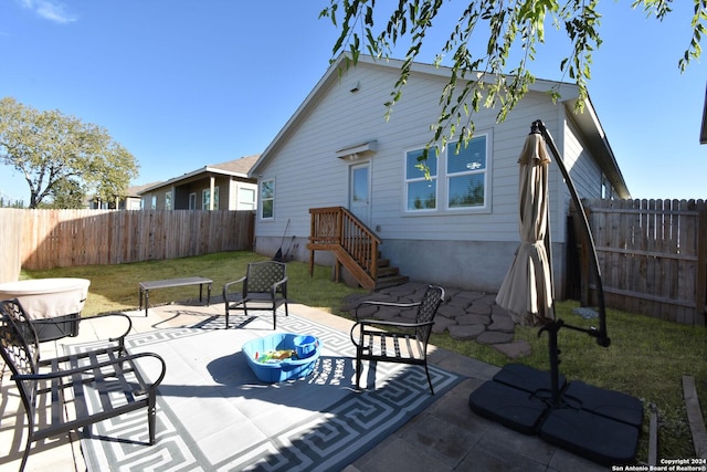 back of house featuring a patio area and a lawn