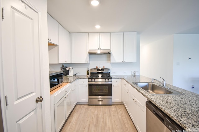 kitchen with white cabinetry, sink, light wood-type flooring, and appliances with stainless steel finishes