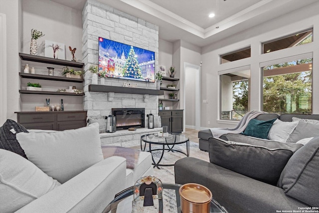 living room with a stone fireplace and hardwood / wood-style floors