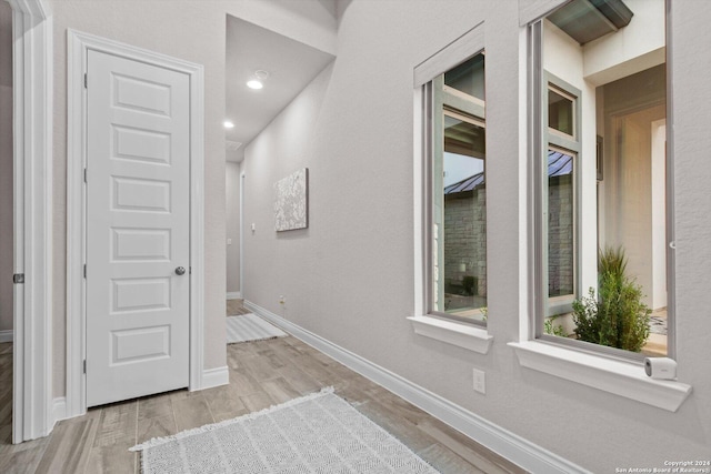 hallway with light hardwood / wood-style flooring