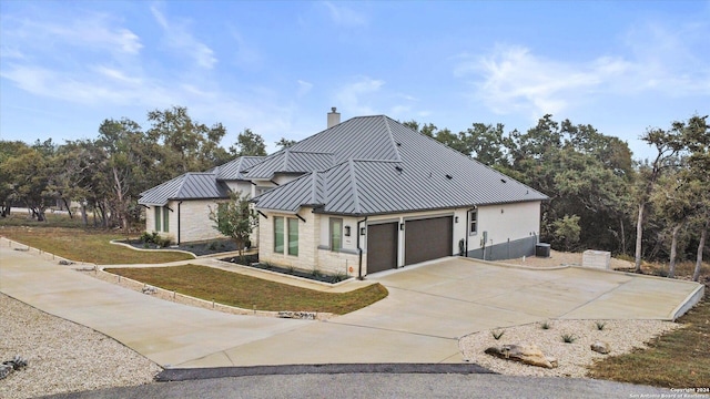 view of side of property with a lawn and a garage