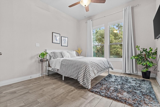 bedroom with ceiling fan and light wood-type flooring