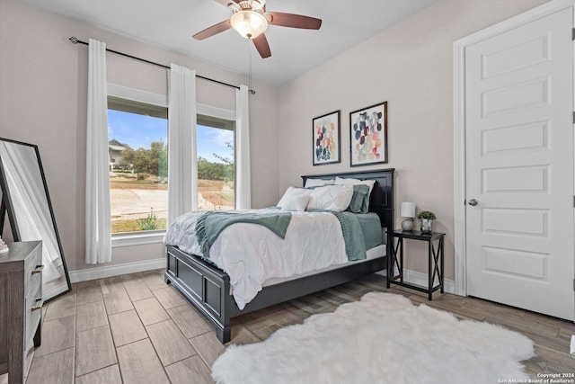 bedroom with ceiling fan and light hardwood / wood-style flooring