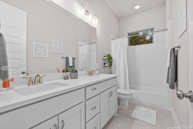 full bathroom with tile patterned flooring, vanity, shower / bath combo, and toilet