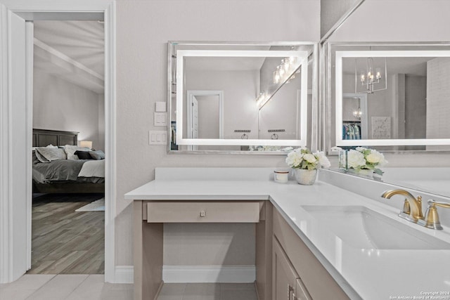 bathroom with vanity, wood-type flooring, and an inviting chandelier