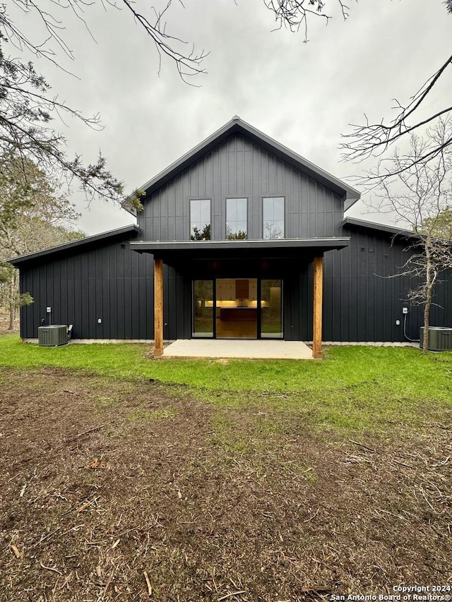 rear view of house with a patio, a lawn, and central air condition unit