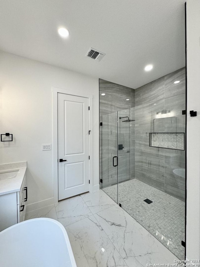 bathroom featuring vanity and separate shower and tub