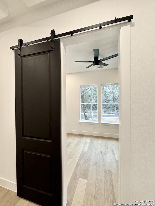 interior space featuring a barn door and light hardwood / wood-style flooring