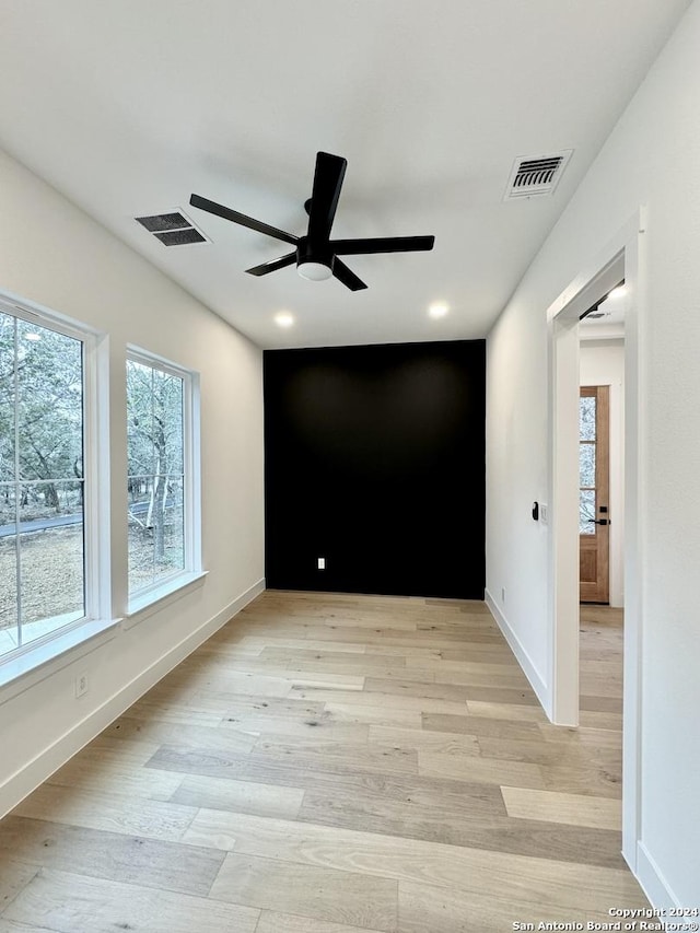 empty room featuring ceiling fan and light hardwood / wood-style flooring