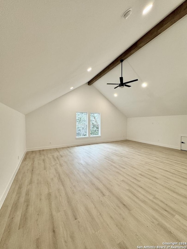 additional living space featuring vaulted ceiling with beams, ceiling fan, and light hardwood / wood-style flooring