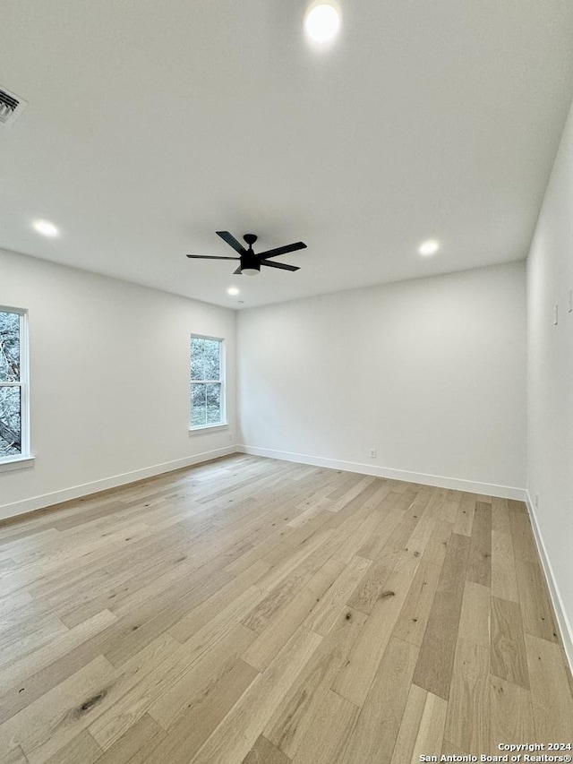 spare room with ceiling fan and light hardwood / wood-style floors