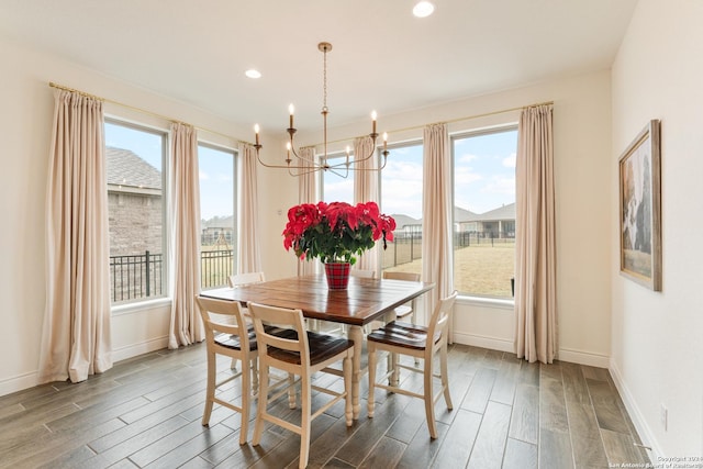 dining area featuring hardwood / wood-style flooring and an inviting chandelier