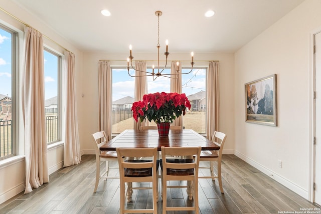 dining room with a chandelier, hardwood / wood-style flooring, and a wealth of natural light