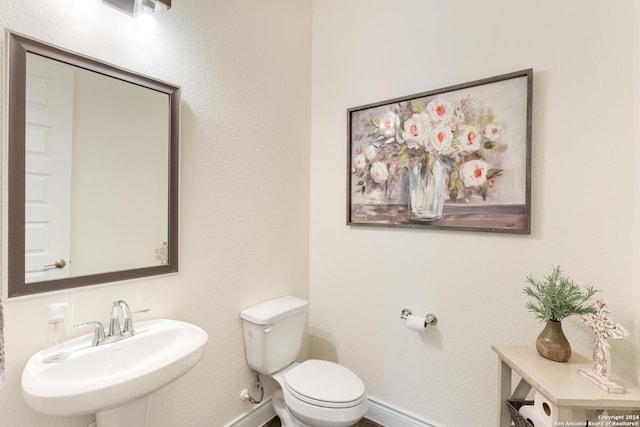 bathroom with toilet and sink