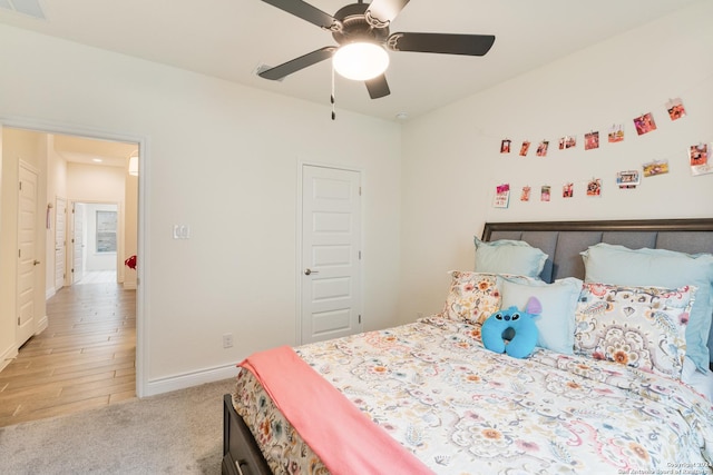 bedroom with ceiling fan and light hardwood / wood-style flooring