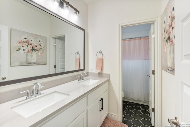 bathroom featuring tile patterned floors, vanity, toilet, and walk in shower