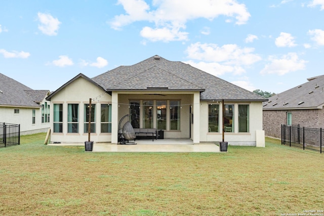 back of house with a lawn and a patio area