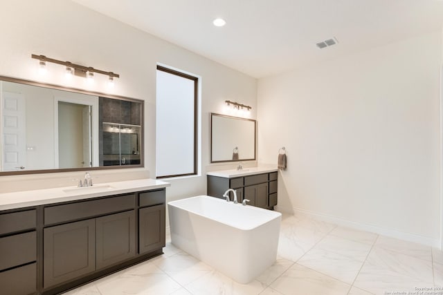 bathroom featuring vanity and a tub