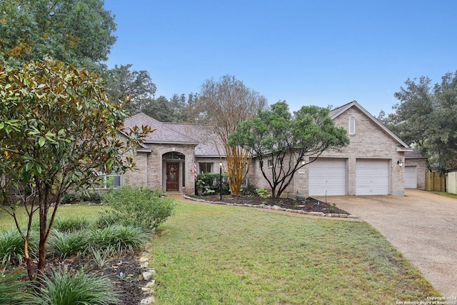 view of front of home with a garage and a front yard